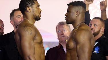 RIYADH, SAUDI ARABIA - MARCH 07: Anthony Joshua (L) and Francis Ngannou (R) face-off at the weigh-in ahead of their 'Knockout Chaos' heavyweight fight at Greece in Boulevard World on March 07, 2024 in Riyadh, Saudi Arabia. (Photo by Richard Pelham / Getty Images)