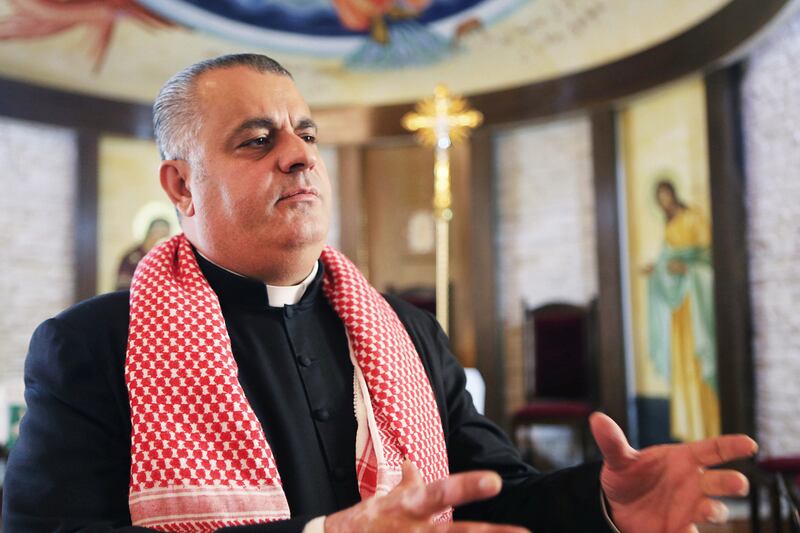 Father Rifat Badr who leads his church in Naour, Jordan, has praised the government for making 'Jordanians one family'. Salh Malkawi for The National