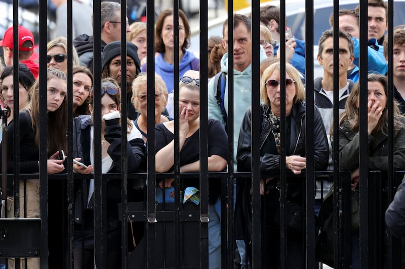 Members of the public look through the gates into Downing Street. Reuters