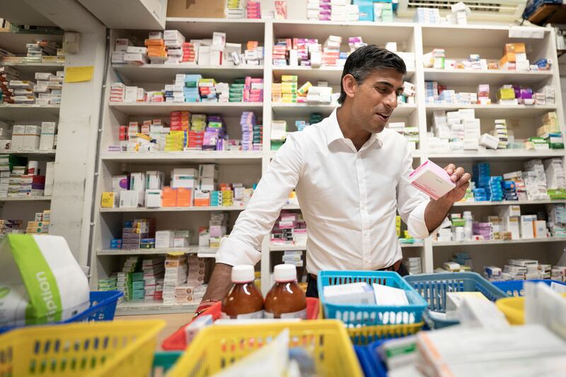 Mr Sunak visits his family's old business, Bassett Pharmacy in Southampton, while on the campaign trail. Reuters