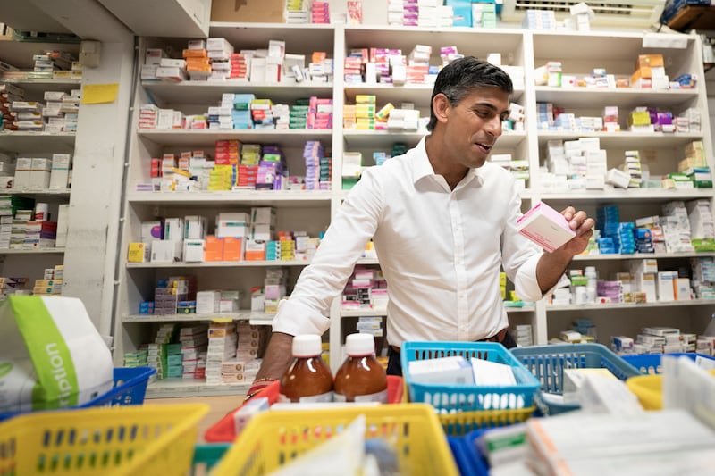 Mr Sunak visits his family's old business, Bassett Pharmacy in Southampton, while on the campaign trail. Reuters