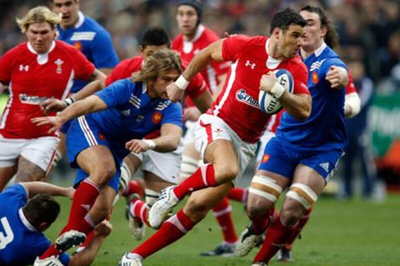 Wales' Mike Phillips evades a tackle from Dimitri Szarzewski at the Stade de France.