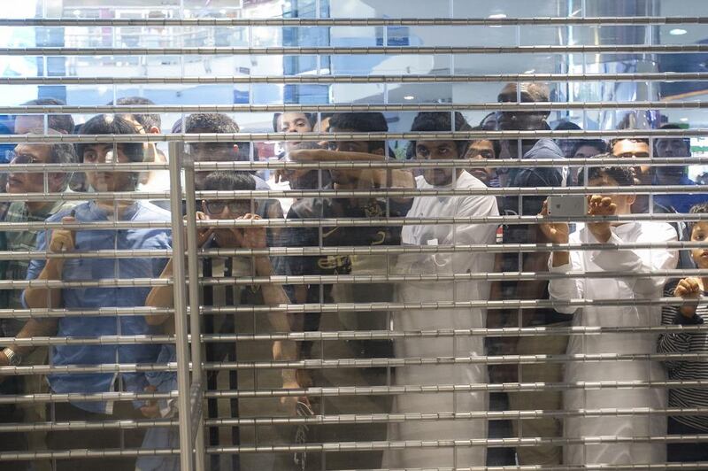 Fans peer in to the store at Marina Mall in Abu Dhabi where Manchester City players Samir Nasri, Stevan Jovetic and Matija Nastasic made an appearance on Tuesday. Mona Al-Marzooqi / The National / May 13, 2014