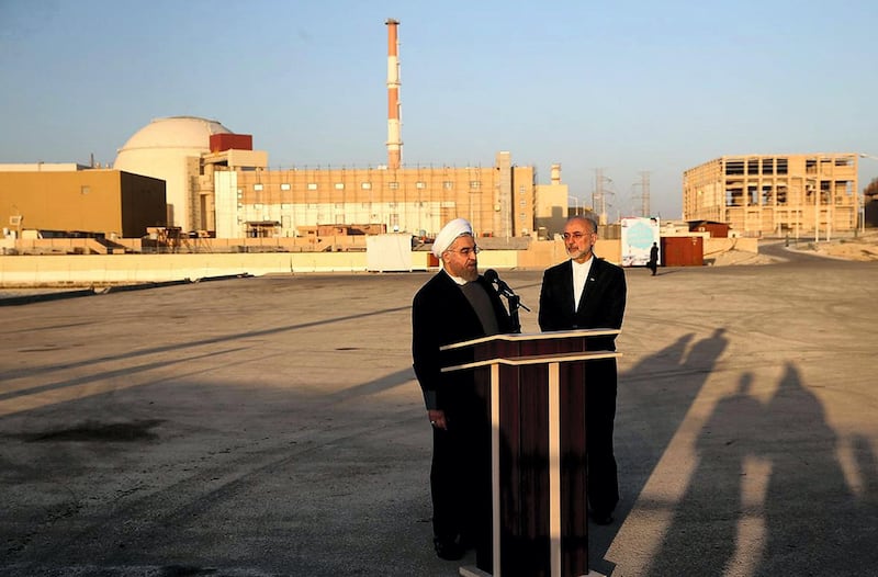 A handout picture released by the official website of the Iranian President Hassan Rouhani, shows him (L) and Iran's Atomic Energy Organisation chief Ali Akbar Salehi addressing journalists at the Bushehr nuclear power plant in the Gulf port city of Bushehr on January 13, 2015. Rouhani implicitly warned US lawmakers against adopting any new sanctions linked to Iran's controversial nuclear programme, saying they would fail as his country was beginning to exit the sanctions-era. AFP PHOTO / IRANIAN PRESIDENCY WEBSITE / MOHAMMAD BERNO 
== RESTRICTED TO EDITORIAL USE - MANDATORY CREDIT "AFP PHOTO / IRANIAN PRESIDENCY WEBSITE / MOHAMMAD BERNO " - NO MARKETING NO ADVERTISING CAMPAIGNS - DISTRIBUTED AS A SERVICE TO CLIENTS == (Photo by MOHAMMAD BERNO / IRANIAN PRESIDENCY / AFP)