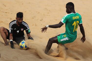 Senegal's Mamour Diagne vies for the ball against Mohamed Aljasmi, left, of United Arab Emirates, during a Group C match of the 2019 FIFA Beach Soccer World Cup at the Los Pynandi Stadium in Luque, Paraguay. EPA