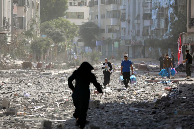 Palestinians leave their homes in Gaza after an Israeli bombardment on Monday. AP
