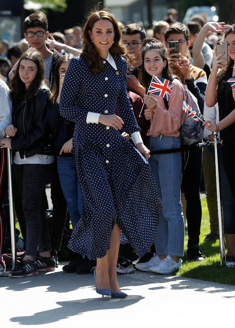 The Duchess of Cambridge wears a pleated polka-dot silk crepe de chine midi dress by Alessandra Rich, with Emmy London Rebecca pumps, a  Smythson Panama Clutch, an antique broach which belonged to her grandmother and Kiki McDonough earrings to visit the D-Day exhibition at Bletchley Park on May 14. Getty Images