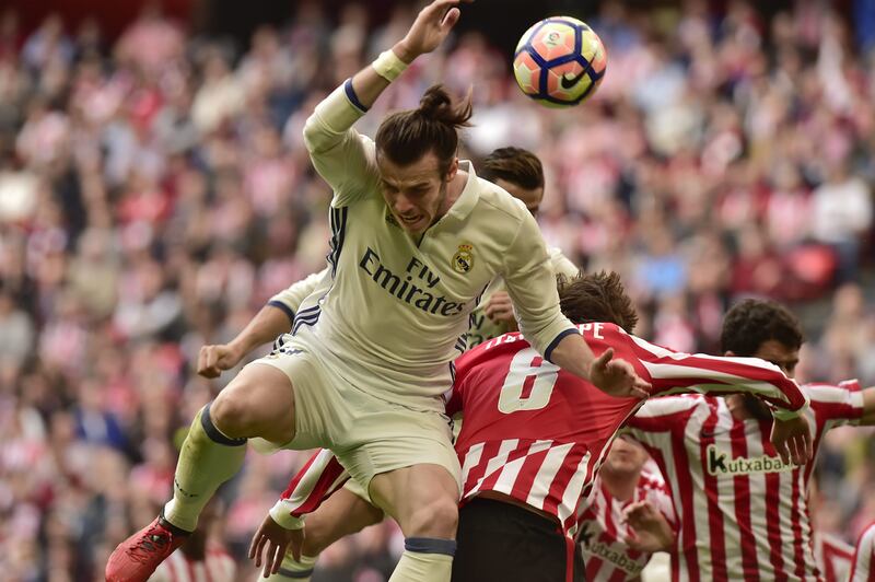 Real Madrid’s Gareth Bale heads the ball against Athletic Bilbao’s Mikel San Jose. Alvaro Barrientos / AP Photo