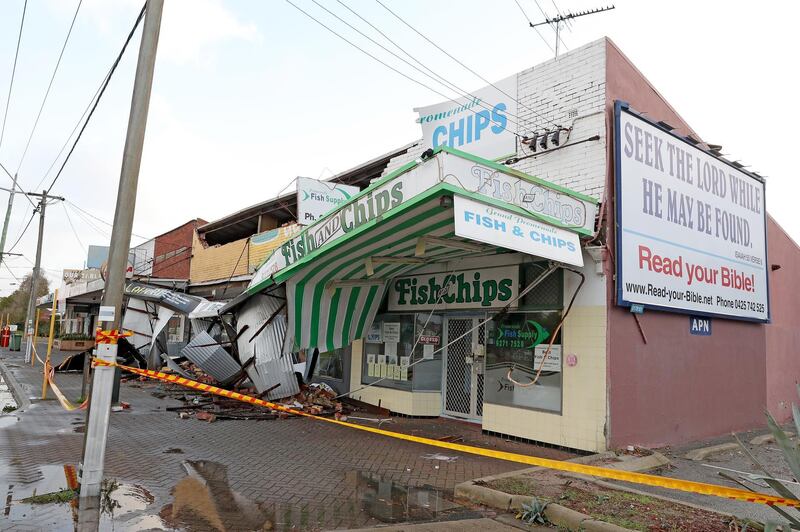 Debris covers a pavement after strong winds damaged shop fronts in Perth, Western Australia.  EPA