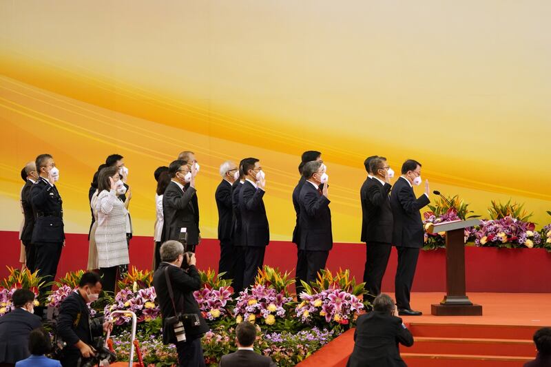 Members of Mr Lee's new Cabinet take their oaths during the ceremony in Hong Kong. Bloomberg