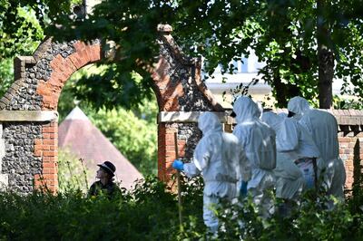 (FILES) In this file photo taken on June 22, 2020 Police forensics officers dressed in Tyvek protective PPE (personal protective equipment) suits and wearing masks, conduct a search as they work outside Forbury Gardens park in Reading, west of London, the scene of the June 20 stabbing spree. A Libyan asylum seeker who executed three men in a knife attack in Reading on June 20, 2020, was jailed for life, a UK court ruled on January 11, 2021. During sentencing at the Old Bailey in London, the judge said Khairi Saadallah, 26, had launched an attack that was so "swift, ruthless and brutal" that none of his three victims had a chance to defend themselves. / AFP / Ben STANSALL
