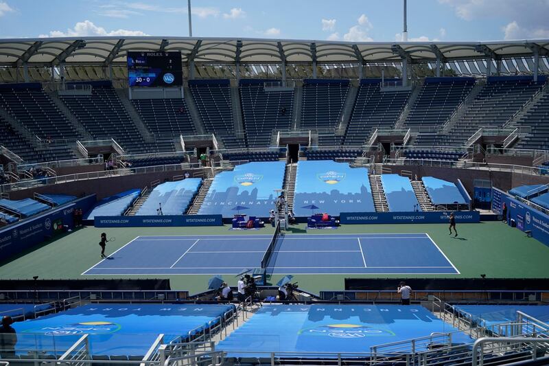 Dutch player Arantxa Rus, right, returns a shot from Serena Williams of the US in front of empty stands at the Southern Open in New York, on Monday, August 24. AP