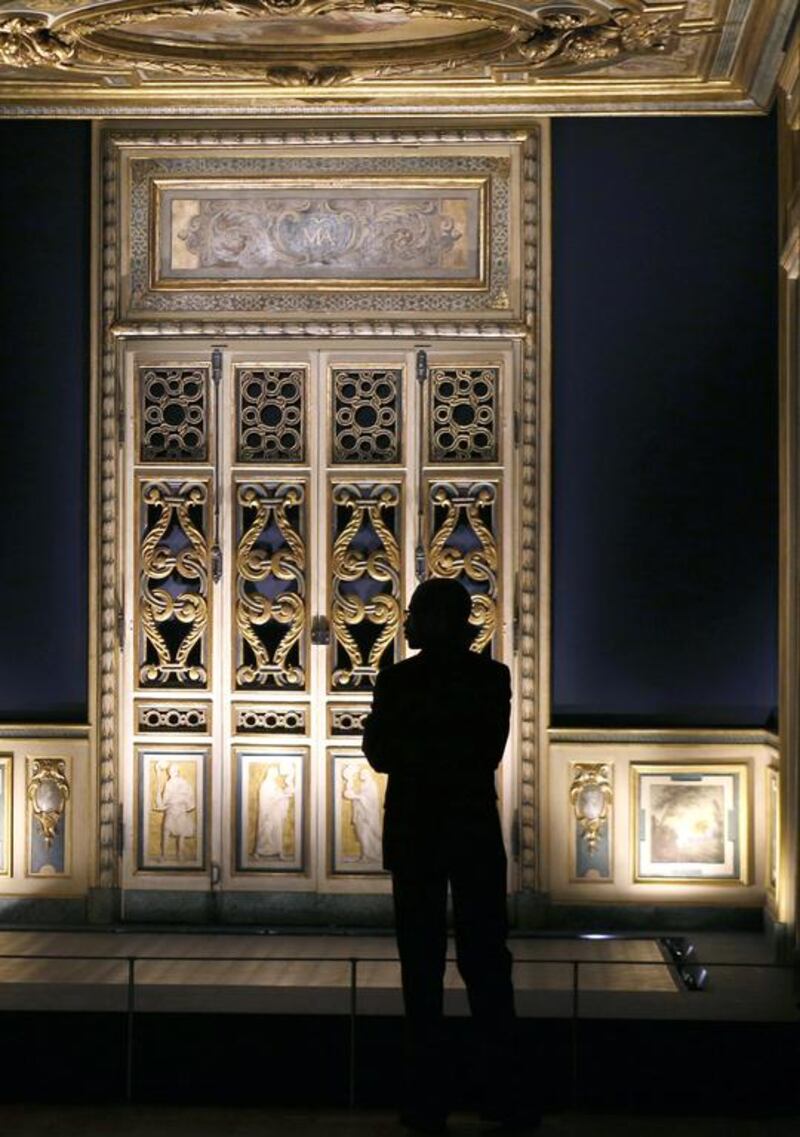 A man looks at 17th century wooden ornamental decorations which originally adorned the inside of a Parisian apartment during an exposition at the Louvre Museum in Paris. Francois Guillot/AFP