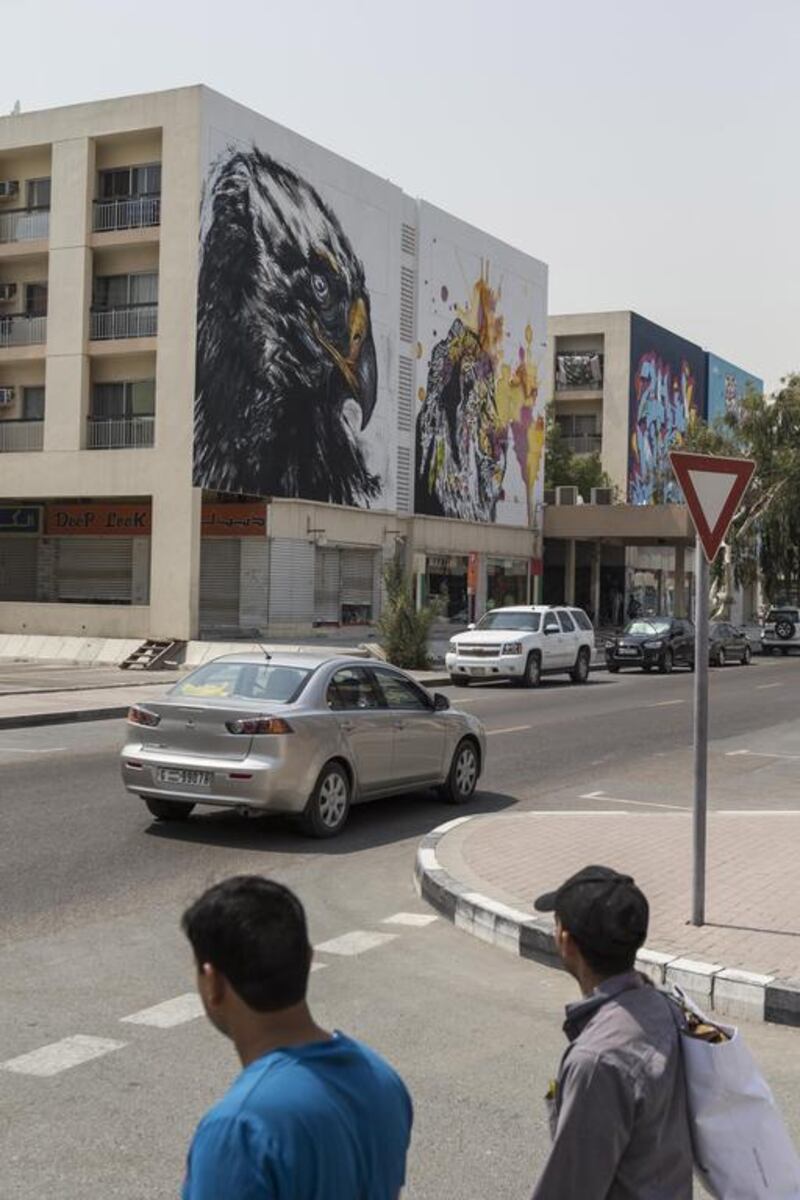 Eight street artists have helped give the area a facelift by painting 24 huge murals on the side of 12 apartment buildings and shops around the Karama shopping complex. Antonie Robertson / The National