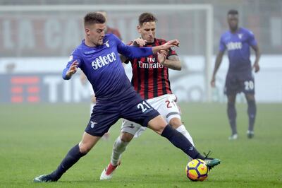 Lazio's Sergej Milinkovic-Savic, left, and AC Milan's Lucas Biglia vie for the ball during a Serie A soccer match between AC Milan and Lazio, at the San Siro stadium in Milan, Italy, Sunday, Jan. 28, 2018. (AP Photo/Luca Bruno)