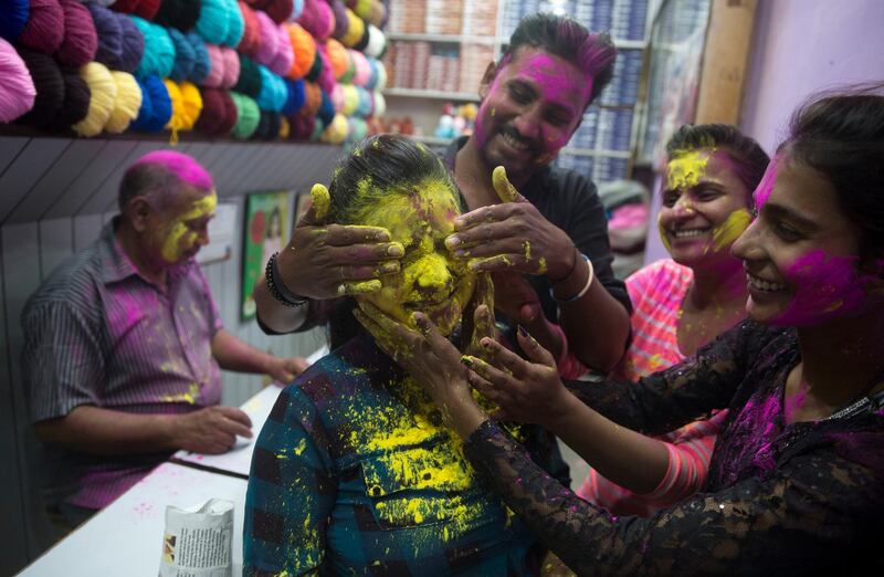 A girl's face is smeared with yellow powder in Allahabad. Rajesh Kumar Singh / AP Photo