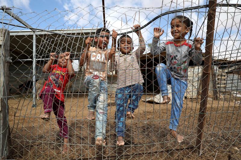Palestinian children play near their tents and shacks in the village of Um Al Kheir near the West Bank town of Hebron. EPA