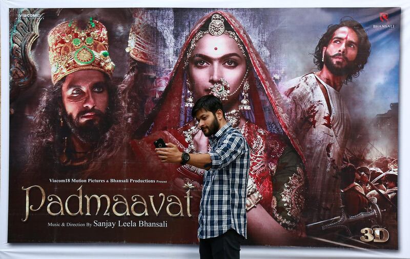 A cinemagoer takes a selfie in front of a poster of Bollywood movie "Padmaavat" outside a movie theatre in Kochi, India, January 25, 2018. REUTERS/Sivaram V     NO RESALES. NO ARCHIVES