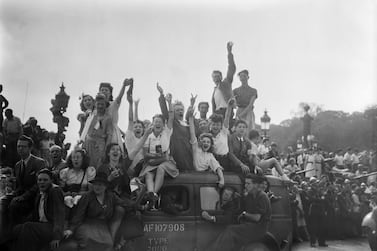 In August 1944, a cheering crowd salutes as they wait for soldiers of the Allied troops on the Place de la Concorde, during the parade to celebrate the Liberation of Paris. AFP