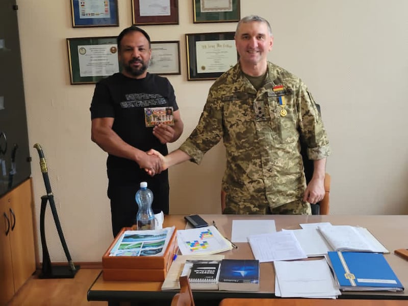 Mr Pal with former general Igor Gordevich, who runs a military boarding school in Kyiv that requires supplies and aid. Photo: Nitesh Pal