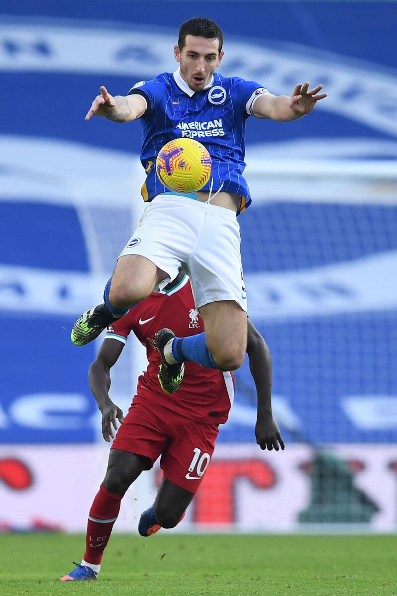 Brighton defender Lewis Dunk jumps to control the ball. AFP