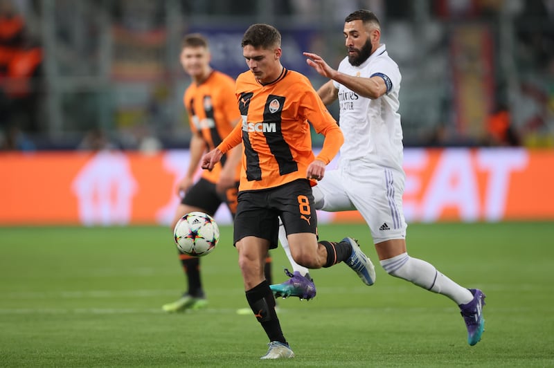 Shakhtar's Georgiy Sudakov battles with Real's Karim Benzema. EPA