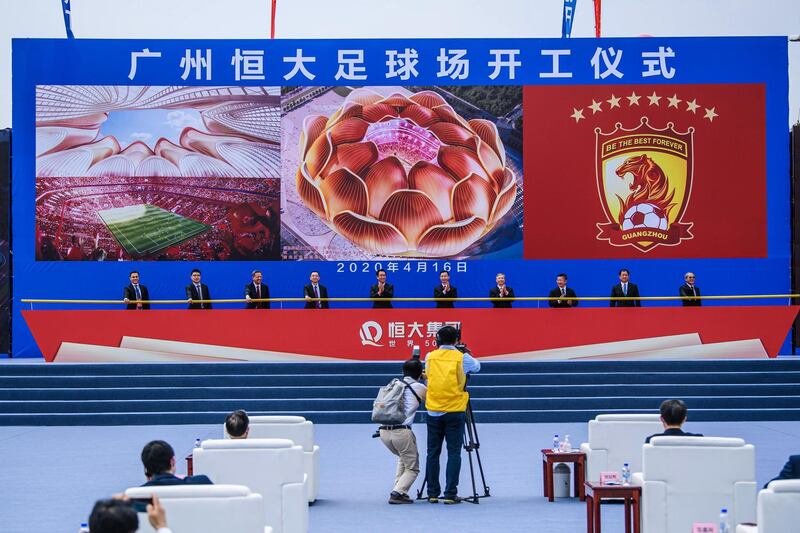 People attend the ground-breaking ceremony of Guangzhou Evergrande's new stadium in Guangzhou. AFP