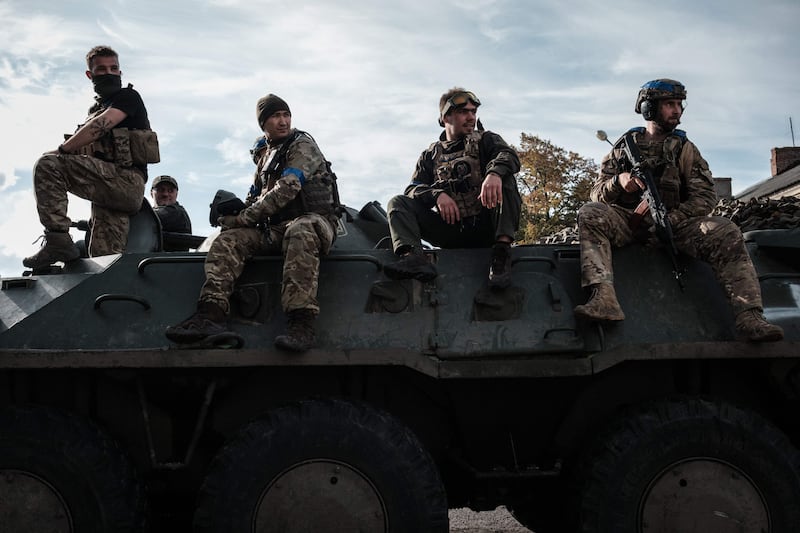 Ukrainian soliders rest on an armoured personnel carrier. AFP