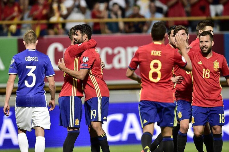 Diego Costa, third left, celebrates scoring the opening goal. Alvaro Barrientos / AP Photo