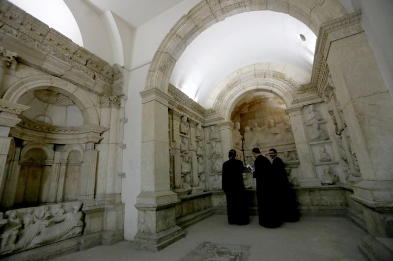 Priests visit the national antiquities museum in the Syrian capital Damascus on October 28, 2018.  Syria reopened a wing of the capital's famed antiquities museum today after six years of closure to protect its exhibits from the civil war. / AFP / LOUAI BESHARA
