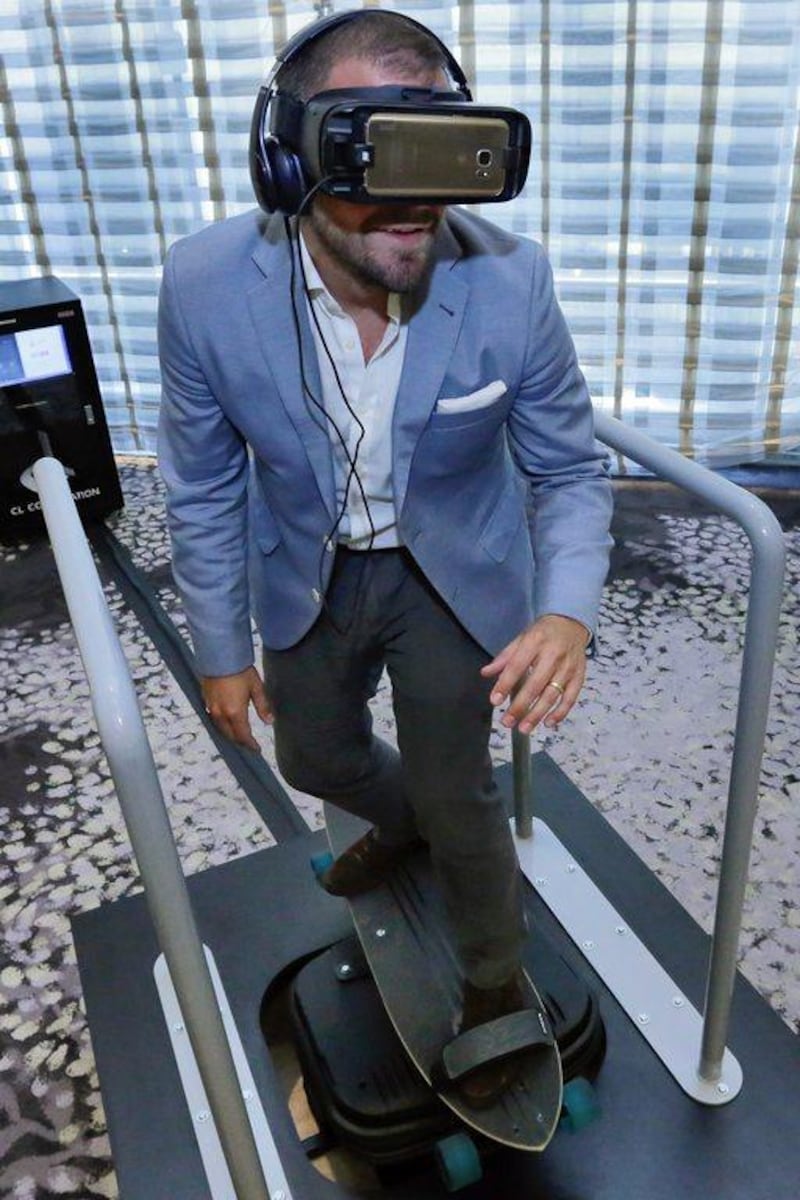 Tom Harding, Samsung's director of immersive products and VR 4D Experience, wears the company's redesigned VR headset as he rides a skateboard simulator in New York. Richard Drew / AP Photo