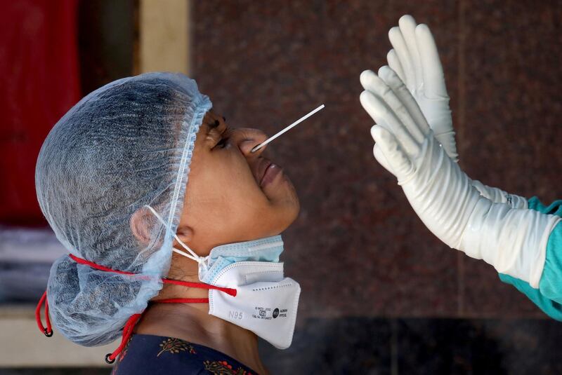 A healthcare worker takes a nasal swab to test for Covid-19 at a government-run hospital in Kolkata, India. Reuters