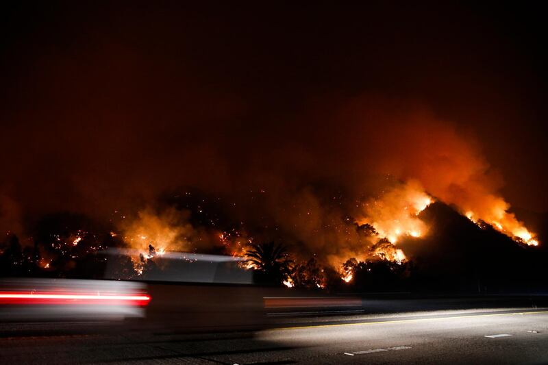 Traffic moves along the Highway 33 as a wildfires continues to burn near Oak View, California. Jae C Hong / AP Photo