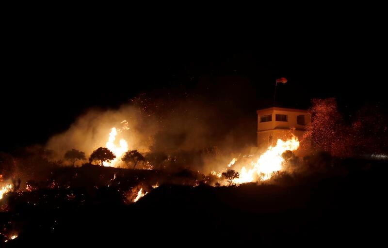 A fire seen from the Israeli side of the border on a Syrian observation post, caused by an Israeli army helicopter attack, on the Israeli-Syrian border next to the village of Majdal Shams, late.  EPA