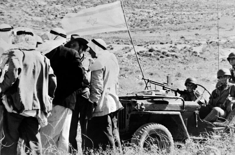 Palestinians speak with Israeli soldiers near a captured Arab village during the 1948 war. AFP