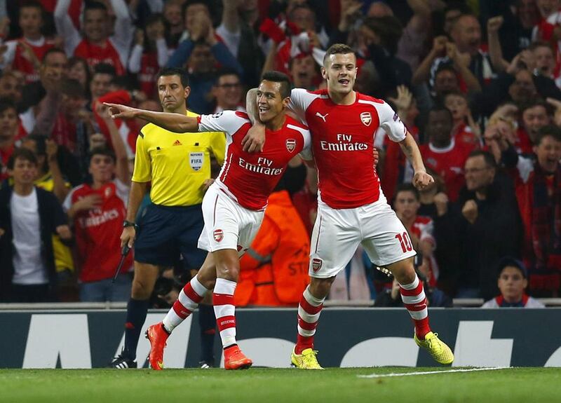 Alexis Sanchez, left, celebrates with Arsenal teammate Jack Wilshere after scoring the winner against Besiktas during their Uefa Champions League qualifier in London. Eddie Keogh / Reuters
