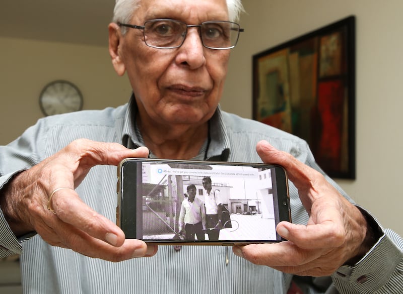 Muljimal Chachara with a photograph of him taken at the old Dubai airport. Victor Besa / The National