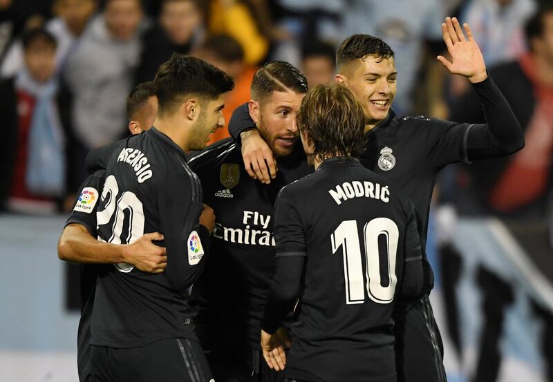 Real Madrid players celebrate with Sergio Ramos after he scores their third goal in the 4-2 win over Celta Vigo. Reuters