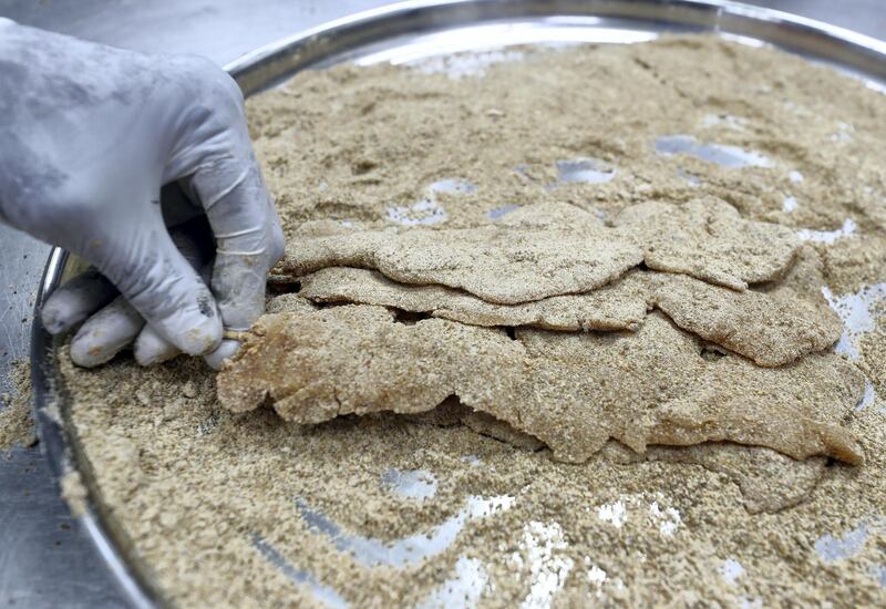 Abu Dhabi, United Arab Emirates - July 24, 2019: The making of Agashai, a chicken dish. Al Mufraka restaurant, one of Abu DhabiÕs small number of Sudanese restaurants. Wednesday the 24th of July 2019. Abu Dhabi. Chris Whiteoak / The National