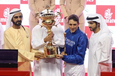 Horse Racing - Dubai World Cup - Meydan Racecourse, Dubai, United Arab Emirates - March 30, 2019 Trainer Saeed bin Suroor and jockey Christophe Soumillon pose with the trophy after winning the Dubai World Cup Sponsored By Emirates Airline on Thunder Snow alongside Dubai's Ruler Sheikh Mohammed bin Rashid al-Maktoum, Prime Minister and Vice-President of the United Arab Emirates REUTERS/Ahmed Jadallah