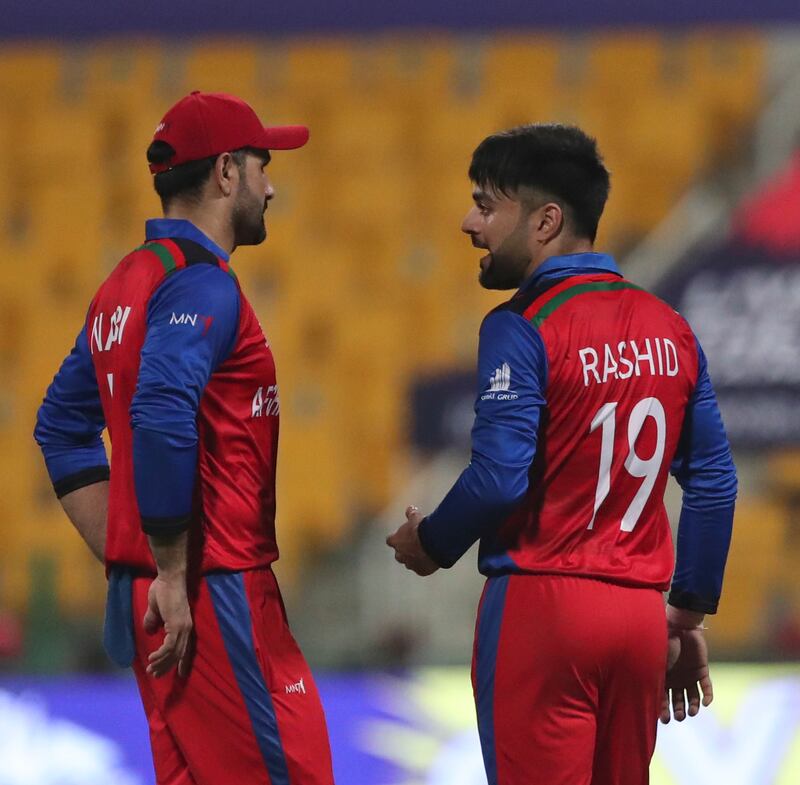 Afghanistan's Rashid Khan, right, talks to captain Mohammad Nabi after he was hit for a six by India's Rohit Sharma. AP Photo