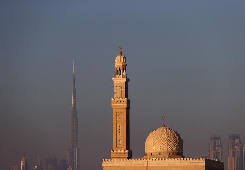 DUBAI, UNITED ARAB EMIRATES - MAY 9 : The Burj Khalia can be seen behind a mosque on May 9 , 2021 in Dubai, United Arab Emirates. Muslim men and women across the world are observing Ramadan, a month long celebration of self-purification and restraint.  (Photo by Francois Nel/Getty Images)