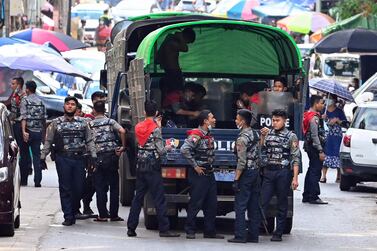 Police talk as they arrive at the site of a demonstration by protesters against the military coup in Yangon on April 12, 2021. AFP