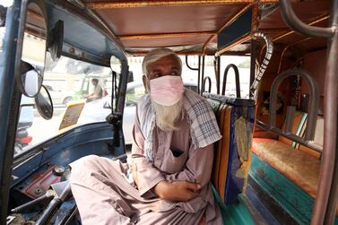 epa09154824 A man wears a face mask inside a Rickshaw, as Pakistan government makes face masks mandatory in public place amid third wave of coronavirus, in Peshawar, Pakistan, 23 April 2021. Prime Minister Imran Khan, announced that a lockdown would not be implemented for now as it will affect the working class and their businesses. He emphasised on the need to wear a mask at all times. PM said help will be taken from the Pakistan Army to implement coronavirus SOPs. EPA/ARSHAD ARBAB