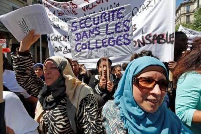 A demonstrator holds a sign reading "Security in the schools" during a protest following recent murders and drug trafficking in Marseille.