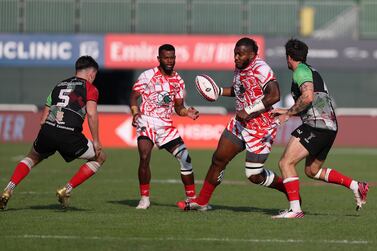 Dubai Tigers (red and white) beat Abu Dhabi Harlequins in the Gulf mens final at the Dubai Rugby 7's. Chris Whiteoak / The National