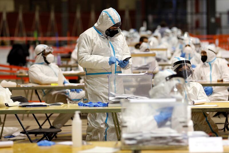 Designated members of the polling stations wear personal protective equipment during the Catalonian regional elections at a poll station in Barcelona, Catalonia, Spain,. EPA