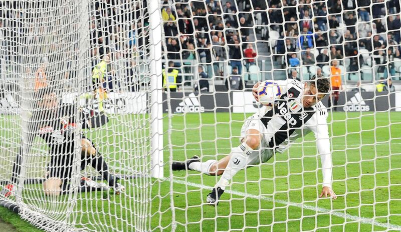 Juventus striker Cristiano Ronaldo retrieves the ball after heading in an equaliser against Torino. EPA