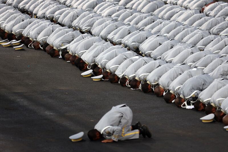 Saudi security forces pray during the parade. AFP