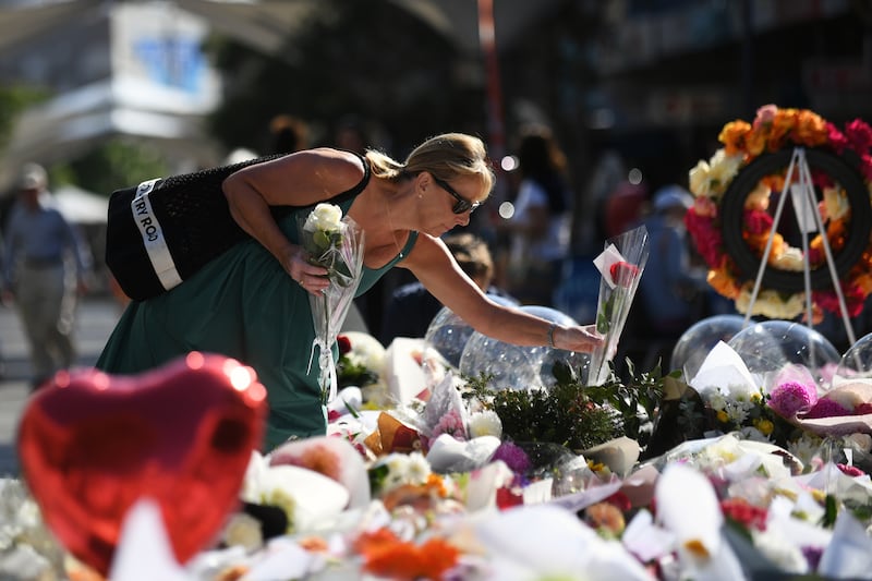 A woman places flowers at the Westfield Bondi Junction shopping centre in Sydney, where seven people were killed in a knife attack. EPA